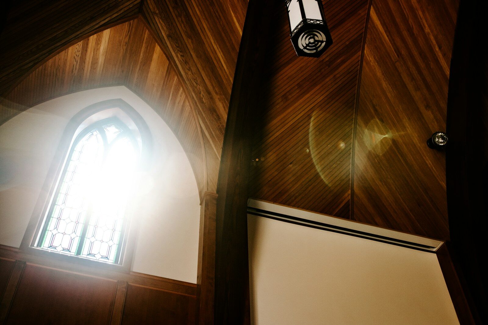 a light shines through a stained glass window